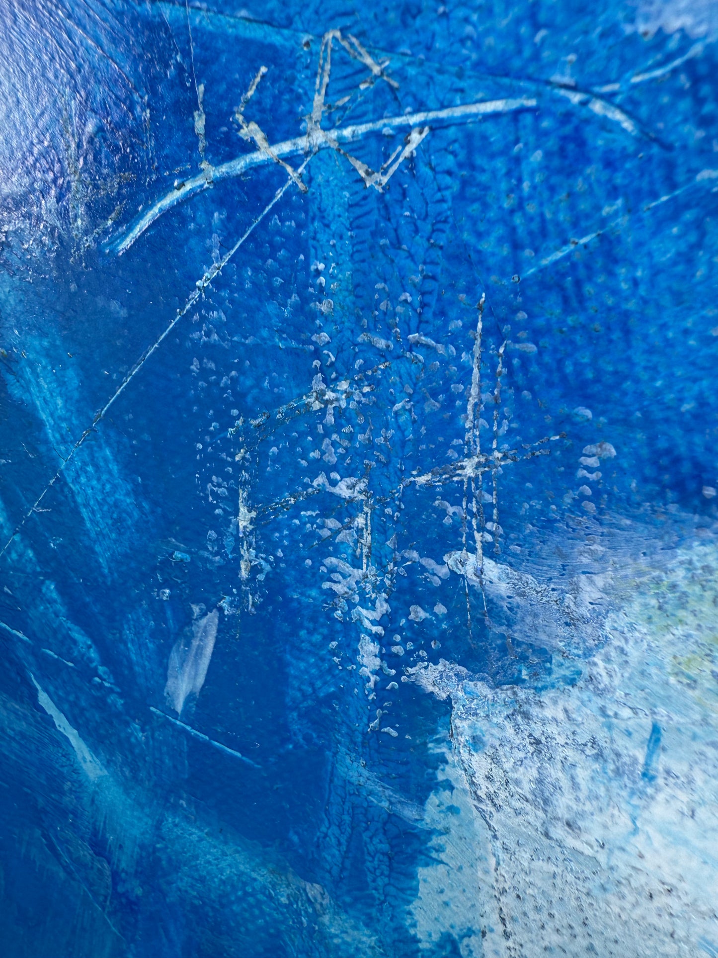 Close-up of a blue textured surface with white lines and patterns