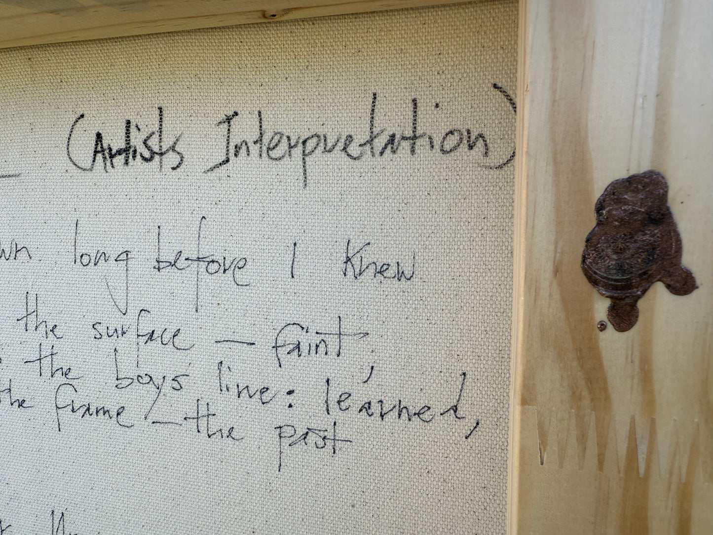 Text on a textured surface with a small brown object to the right